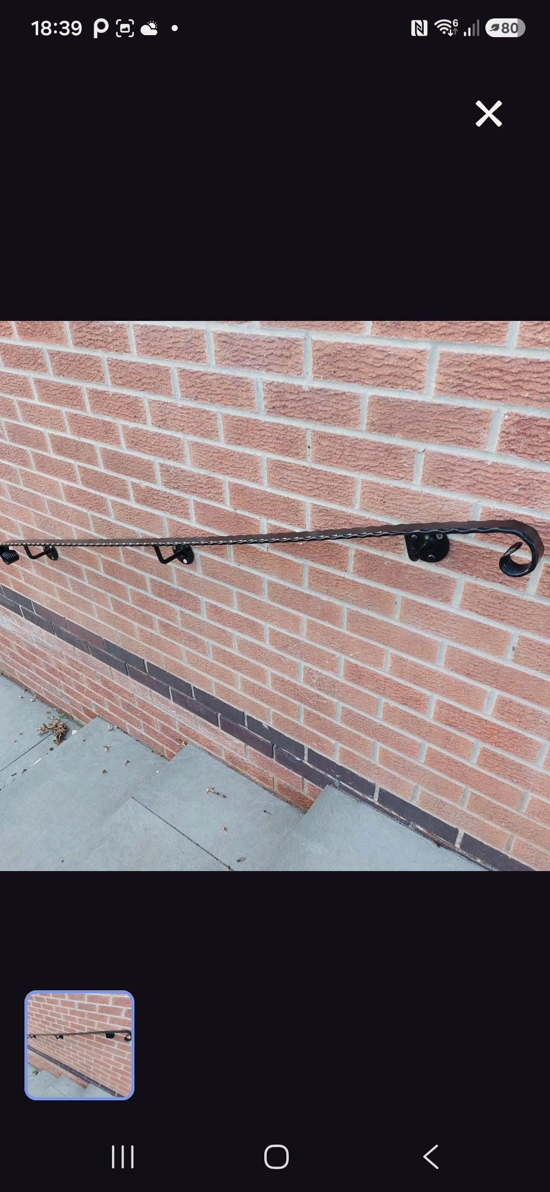Warrior Weld wall mounted hammered wrought iron handrail with scroll end and wall brackets, white background